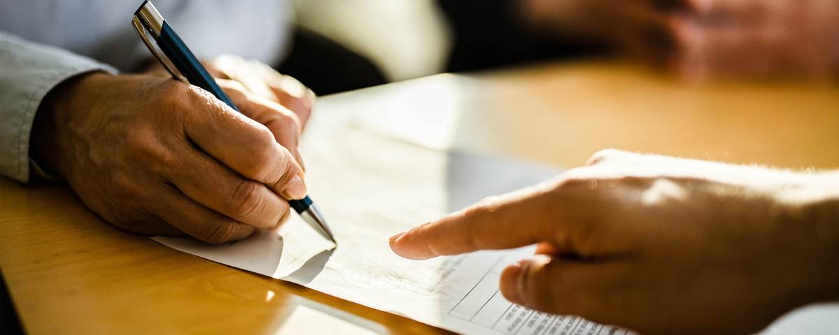 Close-up of carefully arranged paper, pen and professional desk details